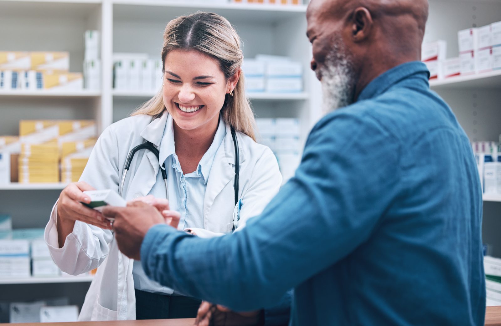 A pharmacist helping a patient at the counter